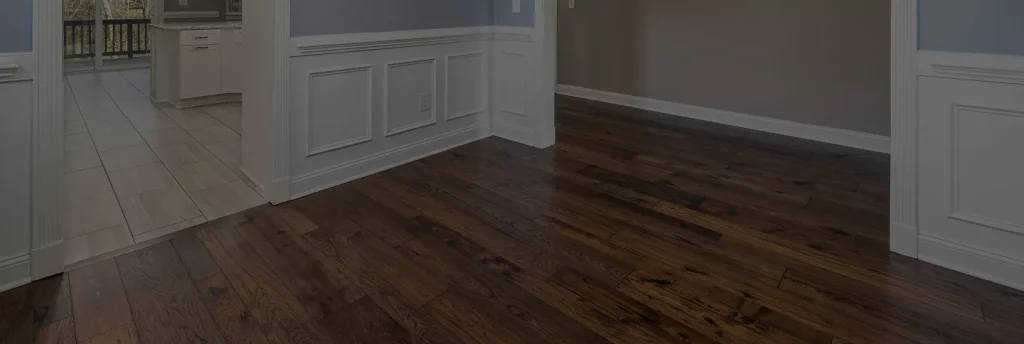 A cozy living room featuring a couch, coffee table, and an air conditioner on the wall.